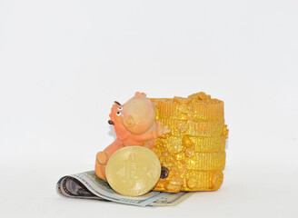 A gold Bitcoin coin and a coin box made from folded dollar bills. Preserving and increasing capital. Cryptocurrency investments. Mining and trading.