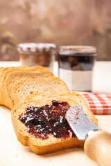 Jam jars, a rustic white table with toast and jam jars, selective focus.