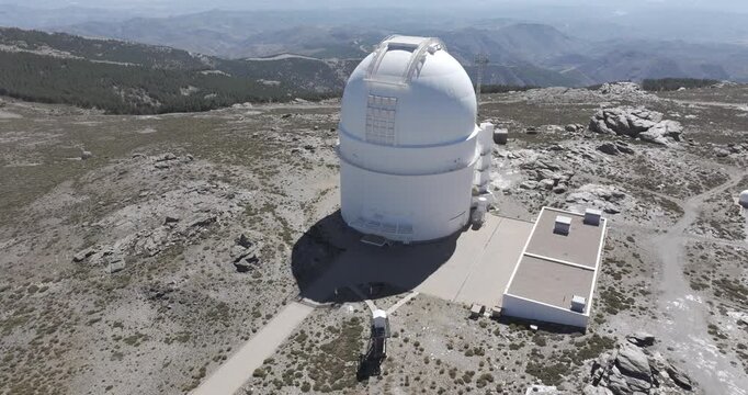 Aerial drone shot of Calar Alto Observatory telescope in the Sierra de Los Filabres mountain range in Almeria, Andalusia, Spain. Largest astronomical observatory in Europe. Drone rising, ascending