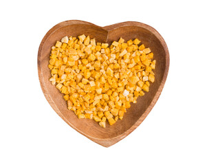 pieces of sublimated mango in a heart-shaped bowl on a white background