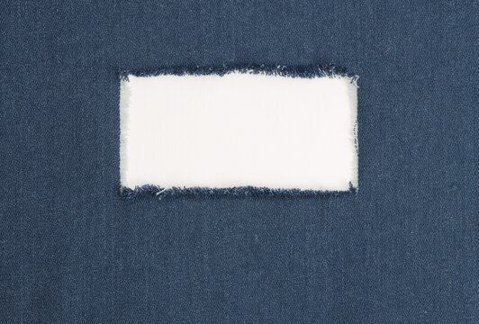 Grunge blue canvas denim fabric with crumpled torn rectangle frame. Texture abstract background.