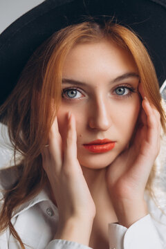 Portrait of a Young Red-Haired Woman in a Black Hat