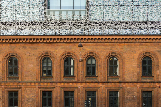 COPENHAGEN, DENMARK - NOVEMBER 01, 2019: N. Zahles Gymnasium Historic Red Brick Facade with Modern White Perforated Roof Extension