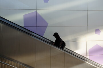 lonely man on escalator