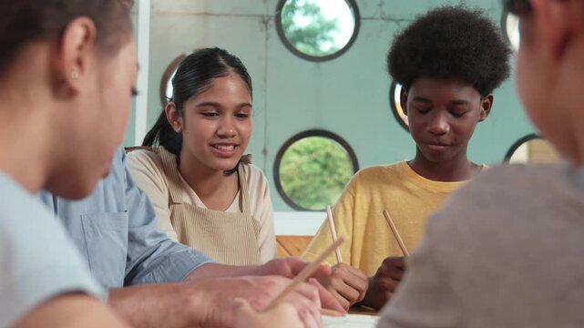 Cute student looking at laptop screen and listen professional caucasian teacher explain. Diverse student working class work while instructor giving advise. Creative education concept. Edification