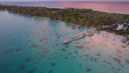 Luxury resort photo of French Polynesia tropical 
paradise islands Fakarava with coral reef. 
Aerial perspective photography with azure ocean, 
sky with clouds on horizon. Pacific Ocean.