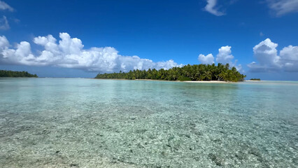 Luxury resort photo of French Polynesia tropical 
paradise island Fakarava with palm trees. Photography with azure ocean, sky with clouds on horizon. Pacific Ocean.