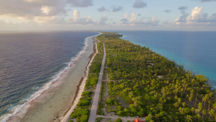 Luxury resort photo of French Polynesia tropical 
paradise islands Fakarava with coral reef. 
Aerial perspective photography with azure ocean, 
sky with clouds on horizon. Pacific Ocean.