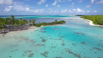 Luxury resort photo of French Polynesia tropical 
paradise island Fakarava with palm trees. Photography with azure ocean, sky with clouds on horizon. Pacific Ocean.