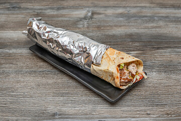 Shawarma in a bowl with a base of rice, your choice of meat, chickpeas, red onion, and a yogurt and lemon dressing