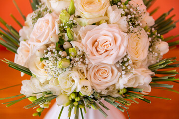 Cream Rose Wedding Bouquet With Greenery, Romantic Bridal Flowers Closeup Against Warm Orange Background Decoration
