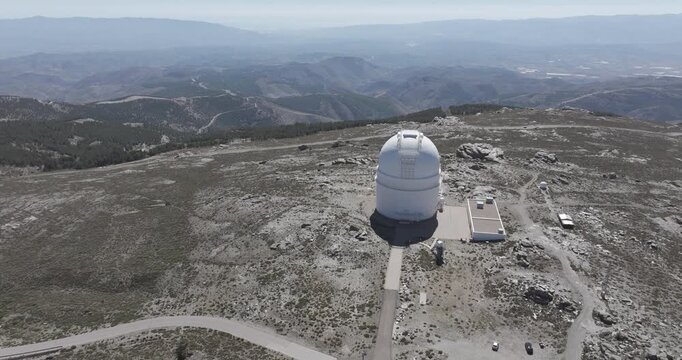 Aerial drone shot of Calar Alto Observatory telescope in the Sierra de Los Filabres mountain range in Almeria, Andalusia, Spain. Largest astronomical observatory in Europe. Sunny, clear blue sky 