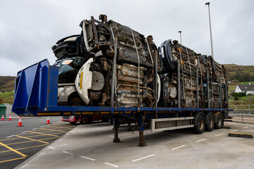 Commercial trailer full of flattened, compressed, cars waiting at a ferry terminal, Uig, Isle of...