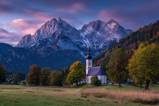Serene Autumn Landscape: Bavaria's Maria Gern Church Framed by Hochkalter Peak at Dawn. A Journey Through Nature's Splendor in the German Countryside.