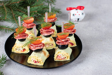 Lavash canape with sausage, black olives and cherry tomatoes