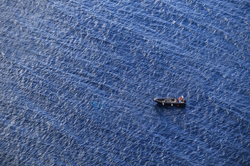 Top view of a black rubber motorboat in the sea. Divers, scuba diving boat on the water background