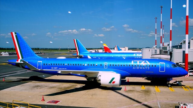 Fiumicino Airport, Rome, Italy, Europe - April 3, 2025 - ITA Airways aircraft preparing for departure at Rome Fiumicino Airport on a sunny day, representing air travel and tourism