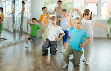 Couple boy and girl rehearsing pair waltz dance in studio