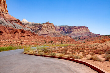 A pullout in Capitol Reef National Park where the rock formations of the uplifted land and one of the domes is in view. 