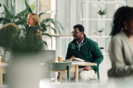 Fototapeta Diverse business professionals collaborating in a modern office
