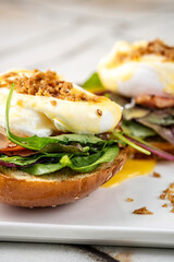 Gourmet poached egg bagel with greens