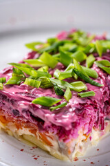 Colorful layered shuba salad with beet and herring