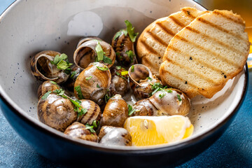 Garlic butter escargot with toast and lemon