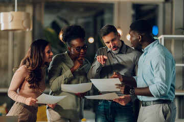 Diverse business team collaborating during a late office meeting