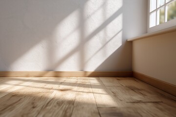 Sunlit minimalist room with wooden floor and white walls