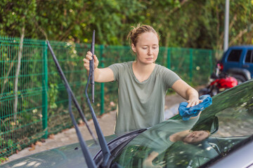 Woman cleaning her car, organizing seats and removing clutter to keep the vehicle tidy. Auto care, cleanliness and everyday routine concept, representing responsibility, order and modern lifestyle