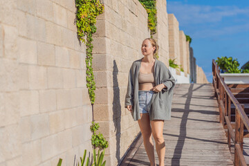 Woman enjoying peaceful time at the beach, relaxing on the sand with ocean views and warm sunlight. Summer leisure, wellbeing and travel concept, representing freedom, calmness and mindful coastal
