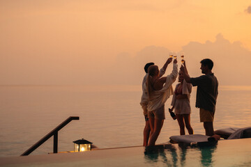 Raising a toast: Family on vacation by the sea, celebrating with champagne