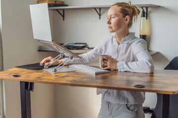 Woman standing at her desk and working in her home office, focused on tasks and productivity. Modern remote work, healthy posture and professional lifestyle concept, representing balance, efficiency