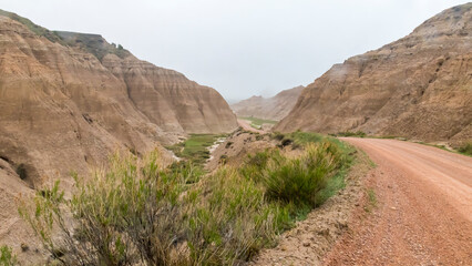 A dirt road going through the back country of the Badlands National Park.