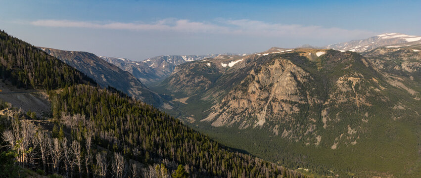 A view of a valley along the Beartooth Highway in Montana with a haze in the background from wildfires.