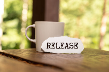 Press Release a lot of stickers are scattered on a wooden background with text on a notepad.