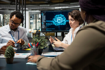 AI unicorn startup staff members discussing tech roadmap during briefing session. Computer scientists developing AI apps in office, brainstorming ways to improve company system metrics