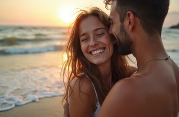 Fototapeta premium Young couple embraces on sandy beach during sunset. Man whispers to smiling woman as waves lap shore. Golden light bathes them, highlighting love and togetherness.