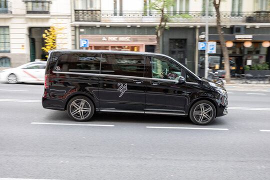 Madrid, spain; 11 05 2025 black minivan driving on city street with motion blur