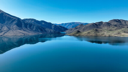 Aerial perspective of  Lake Benmore with the mountains in the background