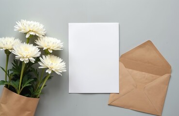 White chrysanthemums rest near blank paper and open envelope. Gift bag holds flowers. Letter for message awaits. Cozy setting for invitation.