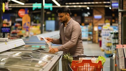 Indian man buying frozen food in a supermarket