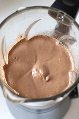 Chocolate smoothie in a blender. Top view. Healthy homemade milkshake for breakfast.