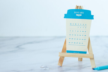 January 2026 paper coffee cup calendar with white background. Copy space. Close-up.