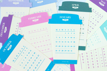 Paper coffee cup calendar with months for 2026 calendar year. Top view.