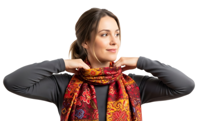 A woman is trying a scarf around her neck, smiling. She wears a grey shirt