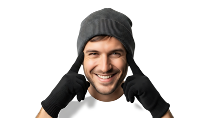 A man wearing winter gear while pointing his index fingers to his eyes. A modern man, smiling and looking directly at the camera, wearing a beanie and gloves.