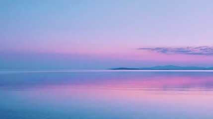 Calm water surface reflects soft pastel colors of the twilight sky over distant low mountains