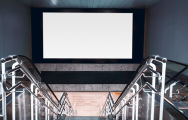 Large blank mock-up billboard above modern stairway with reflective steel rails, clean concrete textures and bright lighting, offering spacious template space for advertising design; banner template
