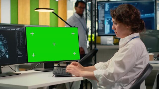 Isolated screen computer used by technician in AI startup office to train predictive models for language processing tasks. IT expert uses deep learning technology on chroma key PC, camera B